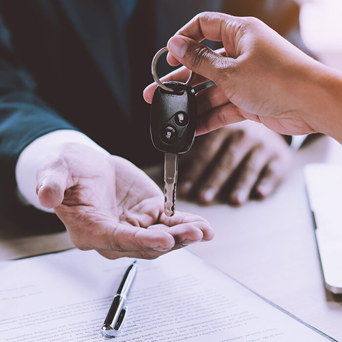 Hands exchanging car keys.